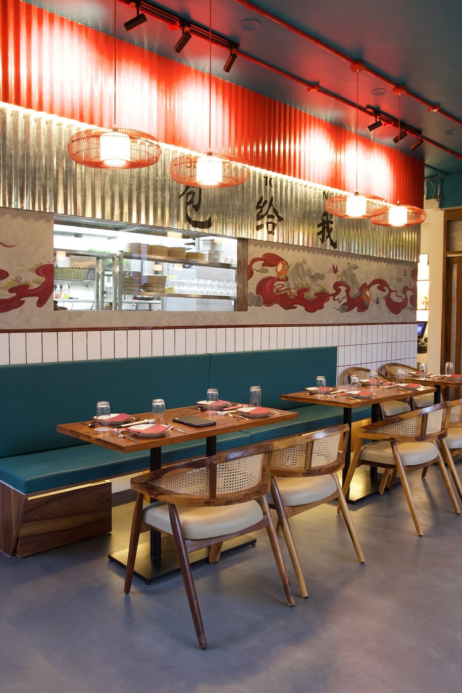 Bao To Me dining room — teal banquette seating and mural